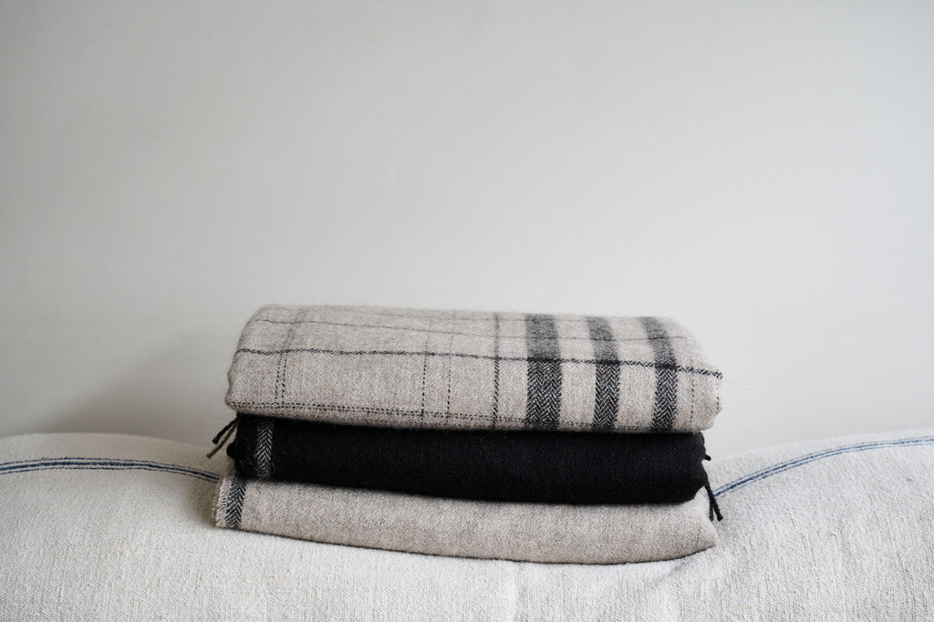 stack-of-alpaca-blankets-in-natural-undyed-colours
