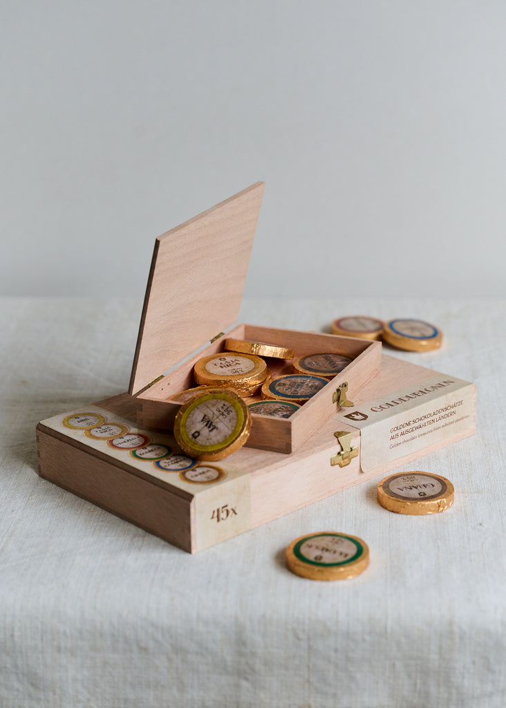 Single origin chocolate coins in a wooden box