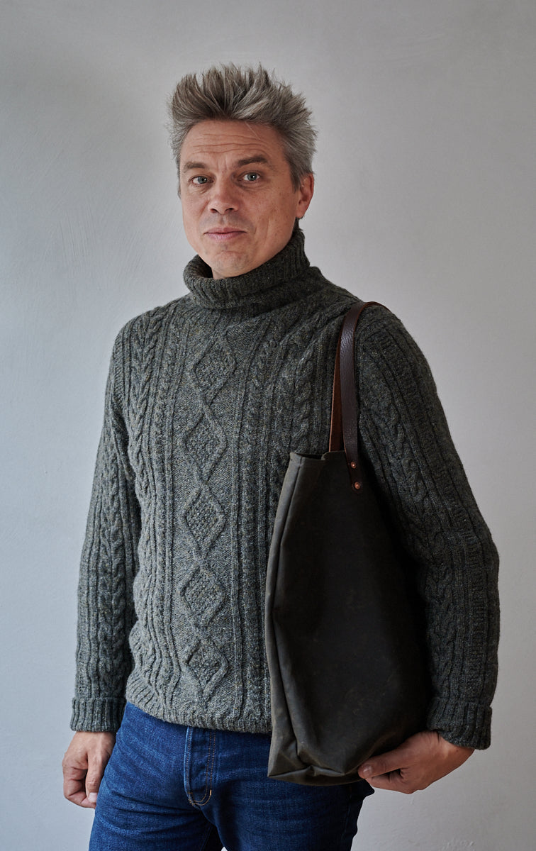 Dark olive bag with wet wax finish and brown leather straps, work with a Freight cable knit jumper deisgned and made in the UK