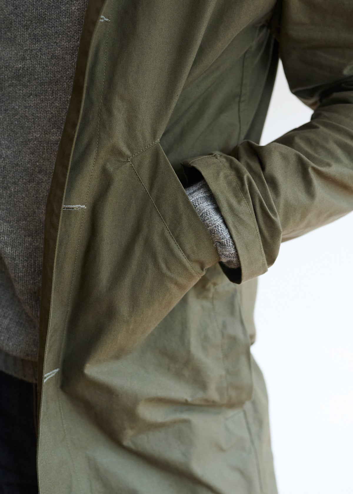 Pocket detail of a dak olive colour men's duster coat made from a drywax cotton fabric
