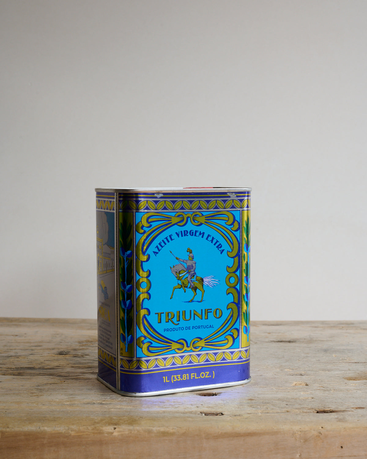 Square tin of portoguese olive oil with bright blue decorative design