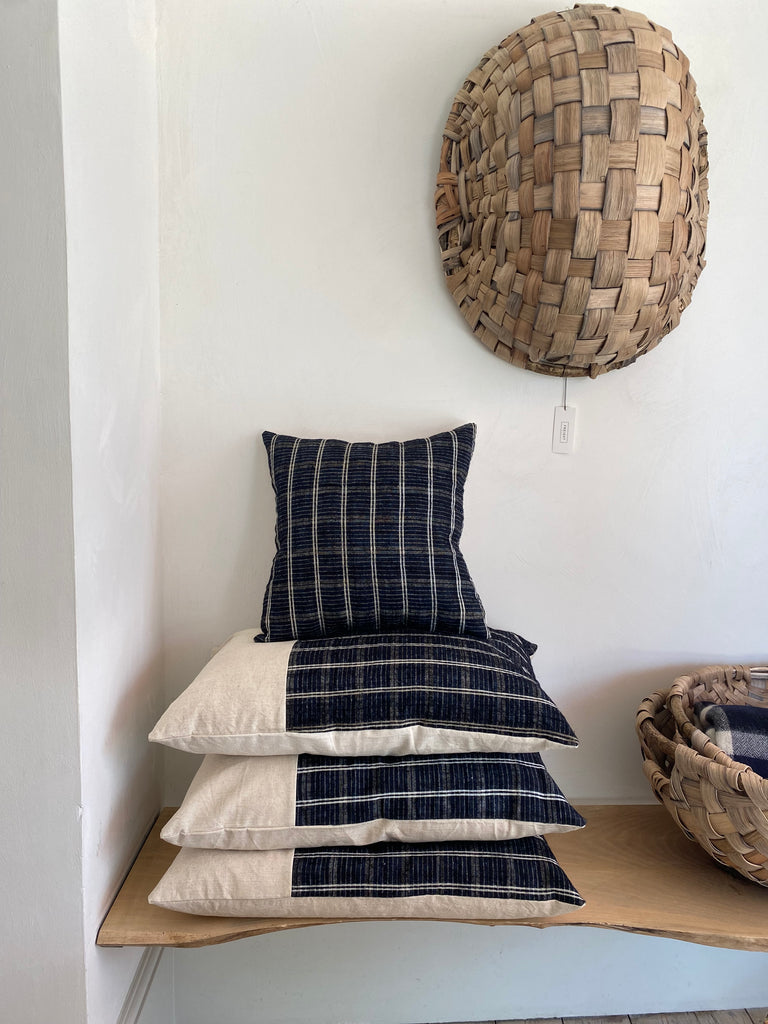 Stack of navy and cream striped cushions