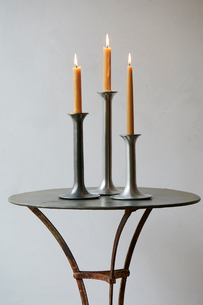 Pewter metal candlsticks in a chrome finish and an aged finish (Tudor)