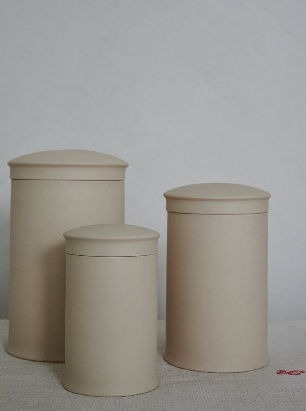 Three stoneware storage jars in three sizes with a matte finish, displayed against a neutral background.